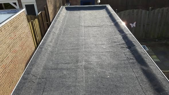 Opgeleverd plat dak overlaagd met APP 470K24 bitumen en aluminium daktrim 60/64 brute Heerjansdam